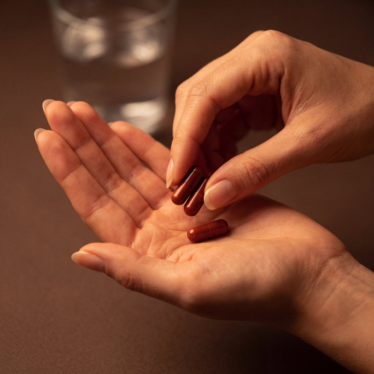 Two TREMODI capsules held in an open palm